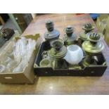 Various oil lamps with a box of funnels and some shades
