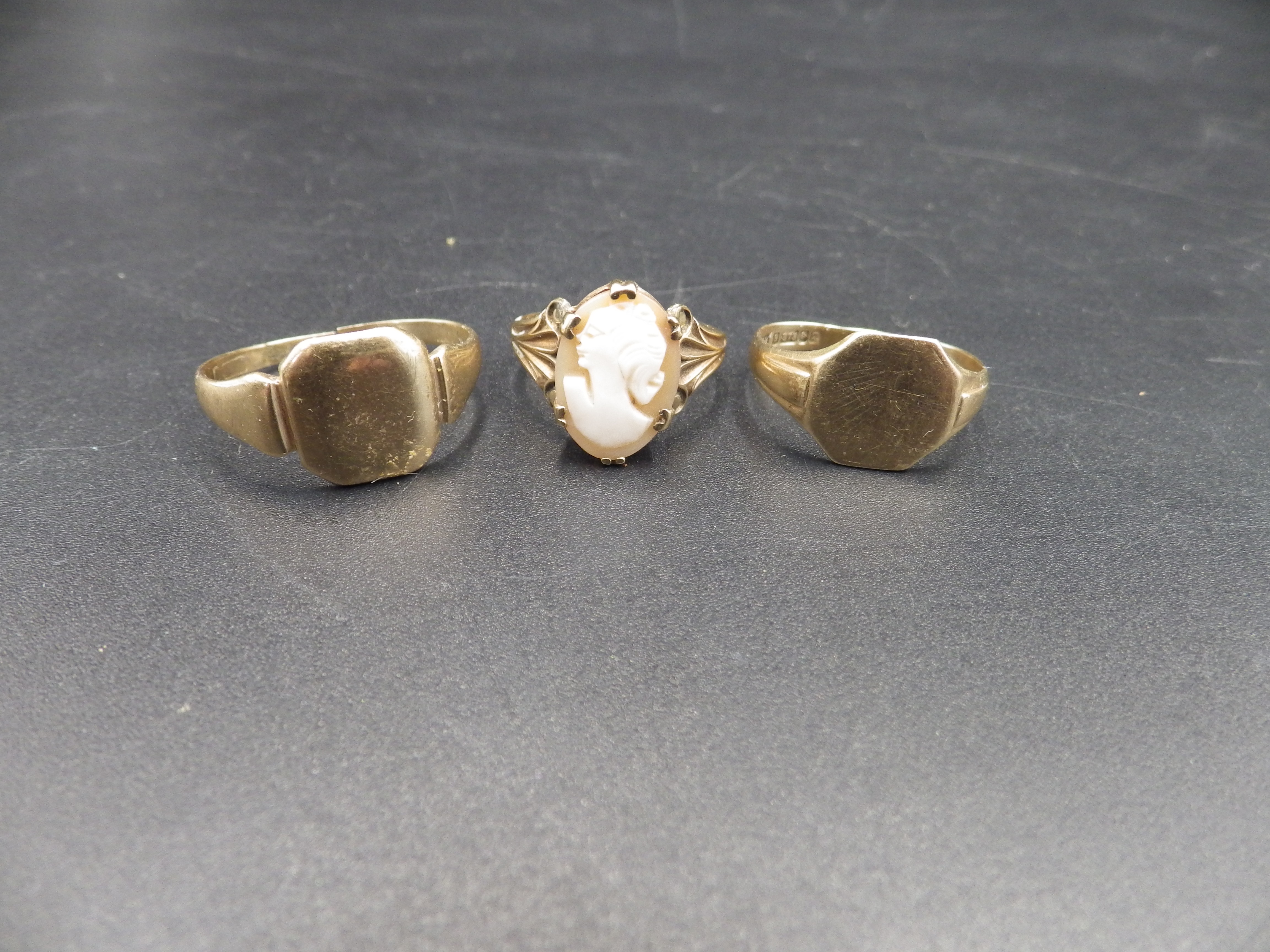 3 x 9ct gold rings (to include a cameo ring) one ring has been cut, 9.51g total lot weight