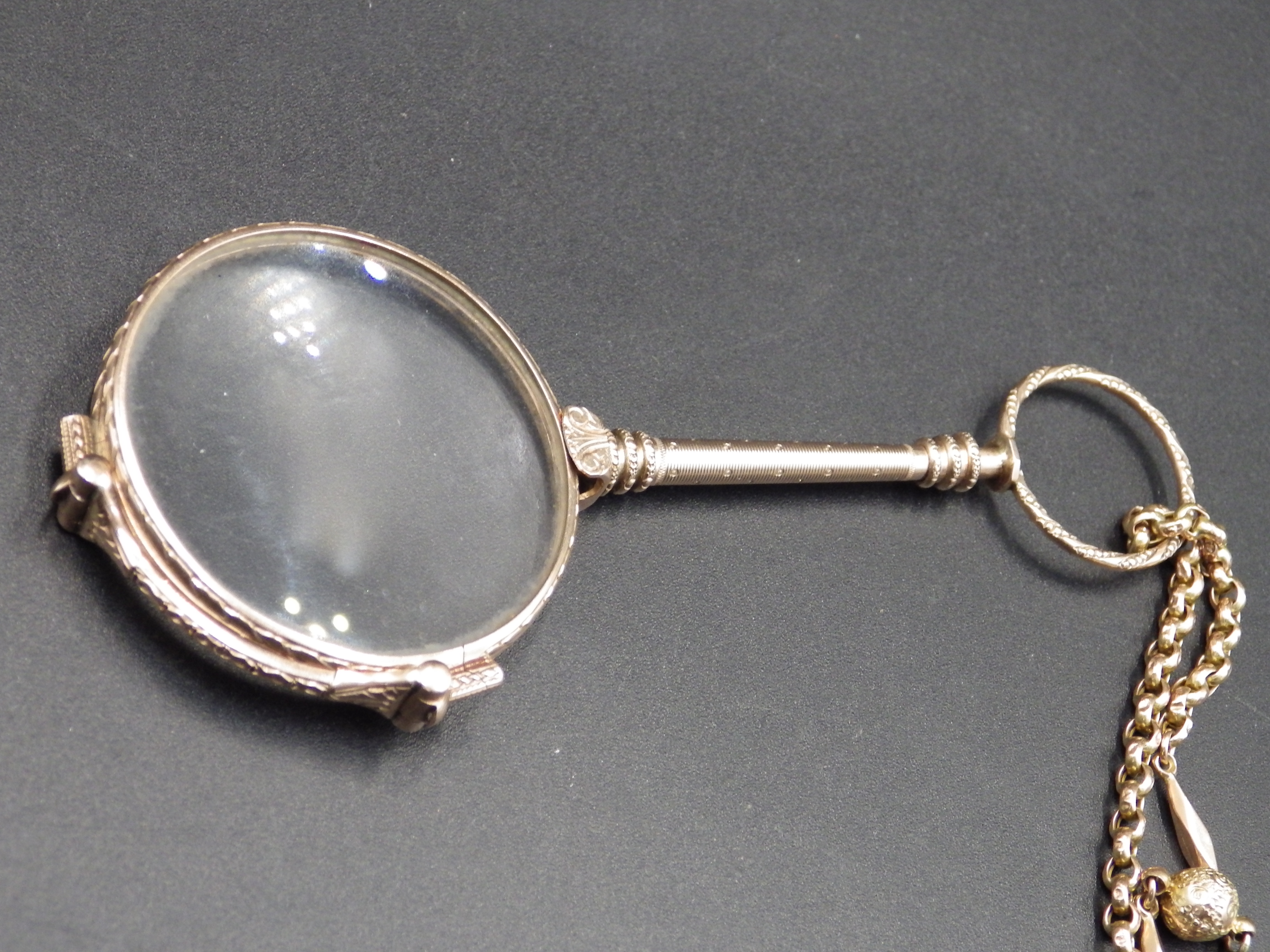 A double lorgnette marked 9 kt, on a gold chain marked 9 ct with decorative sphere detail, the chain - Image 4 of 6