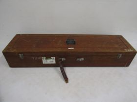 An antique salmon fishing rod transporting case bearing various travel labels