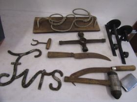 A swing seat, wrought iron sconces, various hand tools