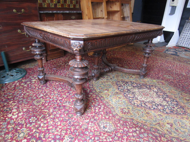 A heavily carved table with lion face details to corners 132x99cm 74cmH 2 rings missing from lion' - Image 9 of 9