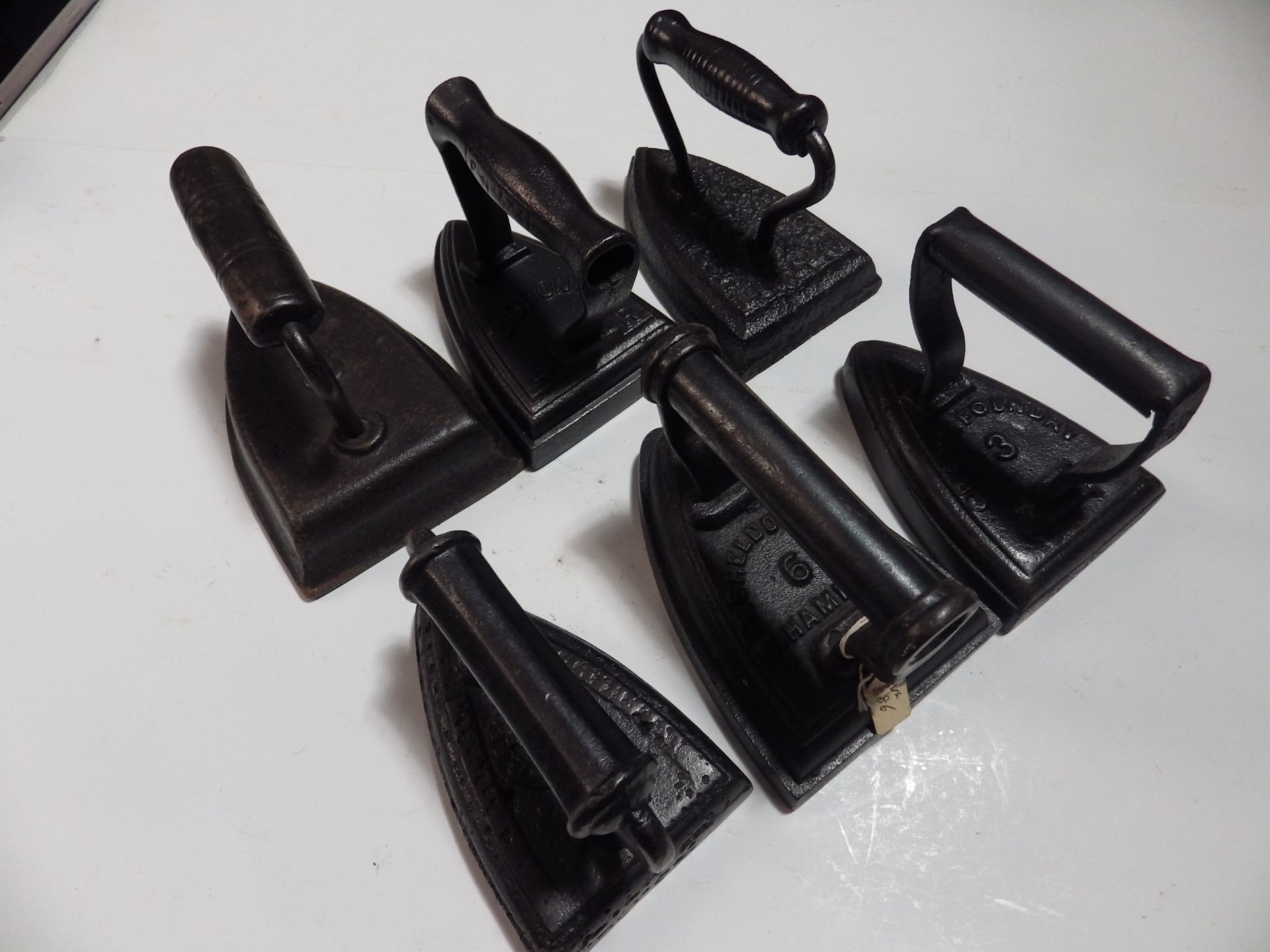 6 various flat/sad irons to incl Crane no 3, T Sheldon & Co 6, Siddons etc