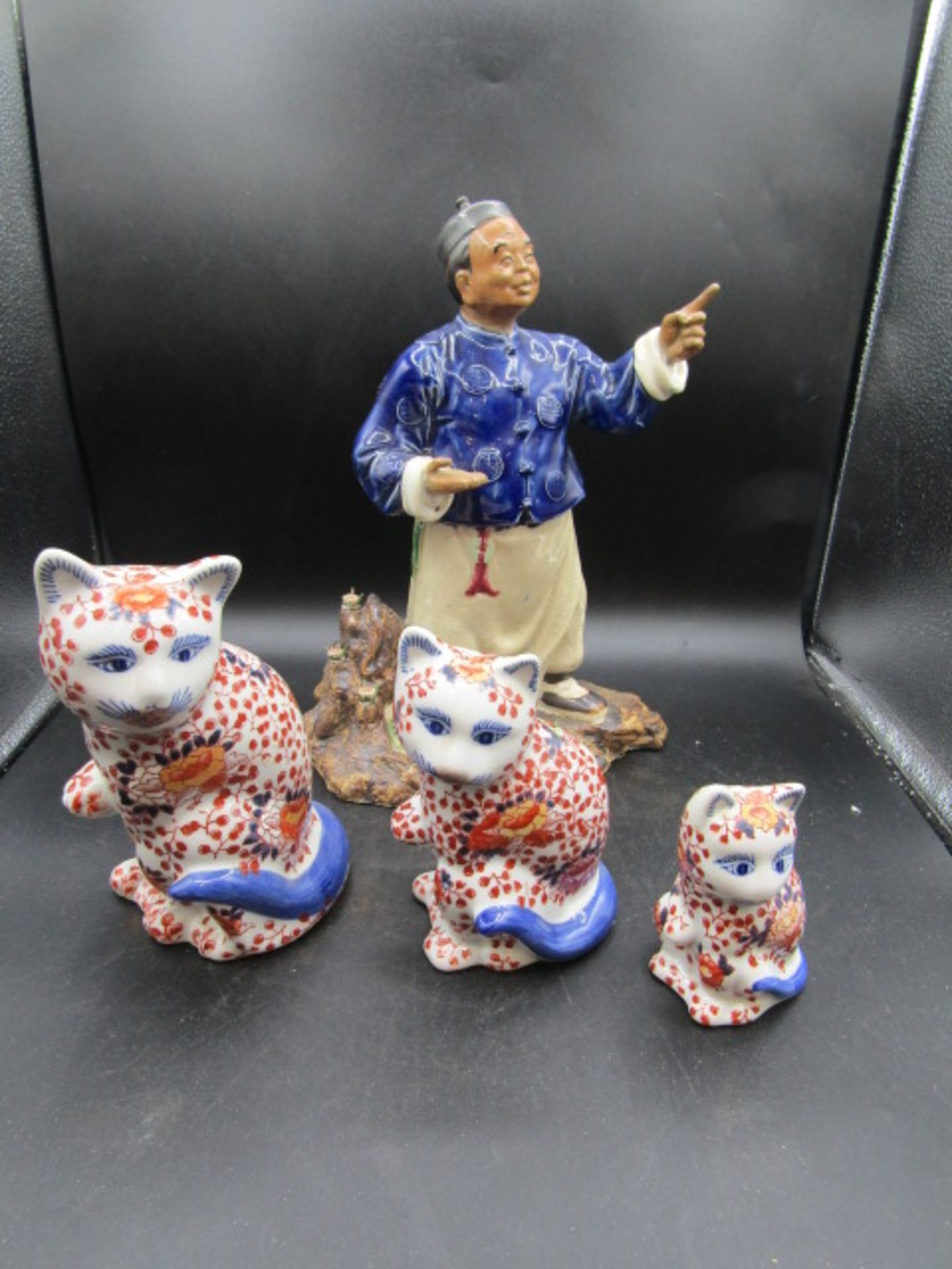 Oriental figure and 3 graduating Oriental cats