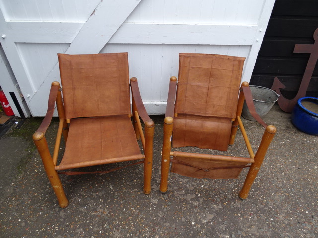 2 Leather Safari/campaign chairs (one chair has been damaged during viewings as shown in amended