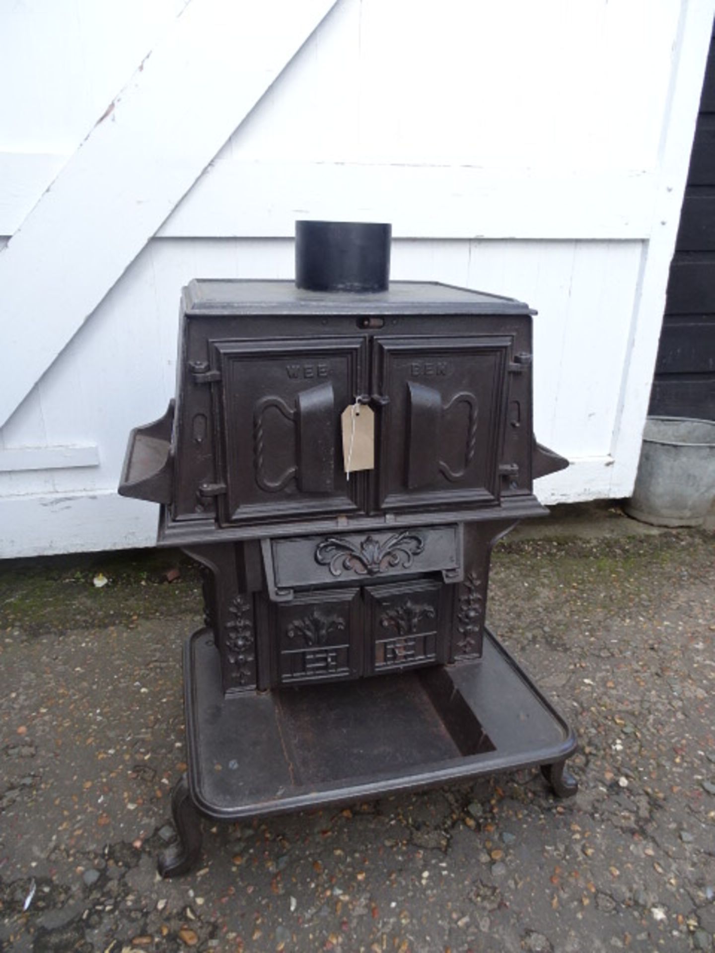 The Wee Ben tailors cast iron laundry stove with ornate door decorations incl two tailor goose irons
