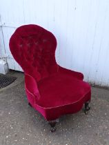 Antique upholstered bedroom chair on brass castors