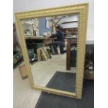 A large bevelled mirror 108x74cm
