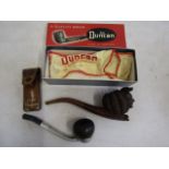 A Falcon pipe and a carved jester pipe in a Duncan box along with pipe cleaner in leather pouch