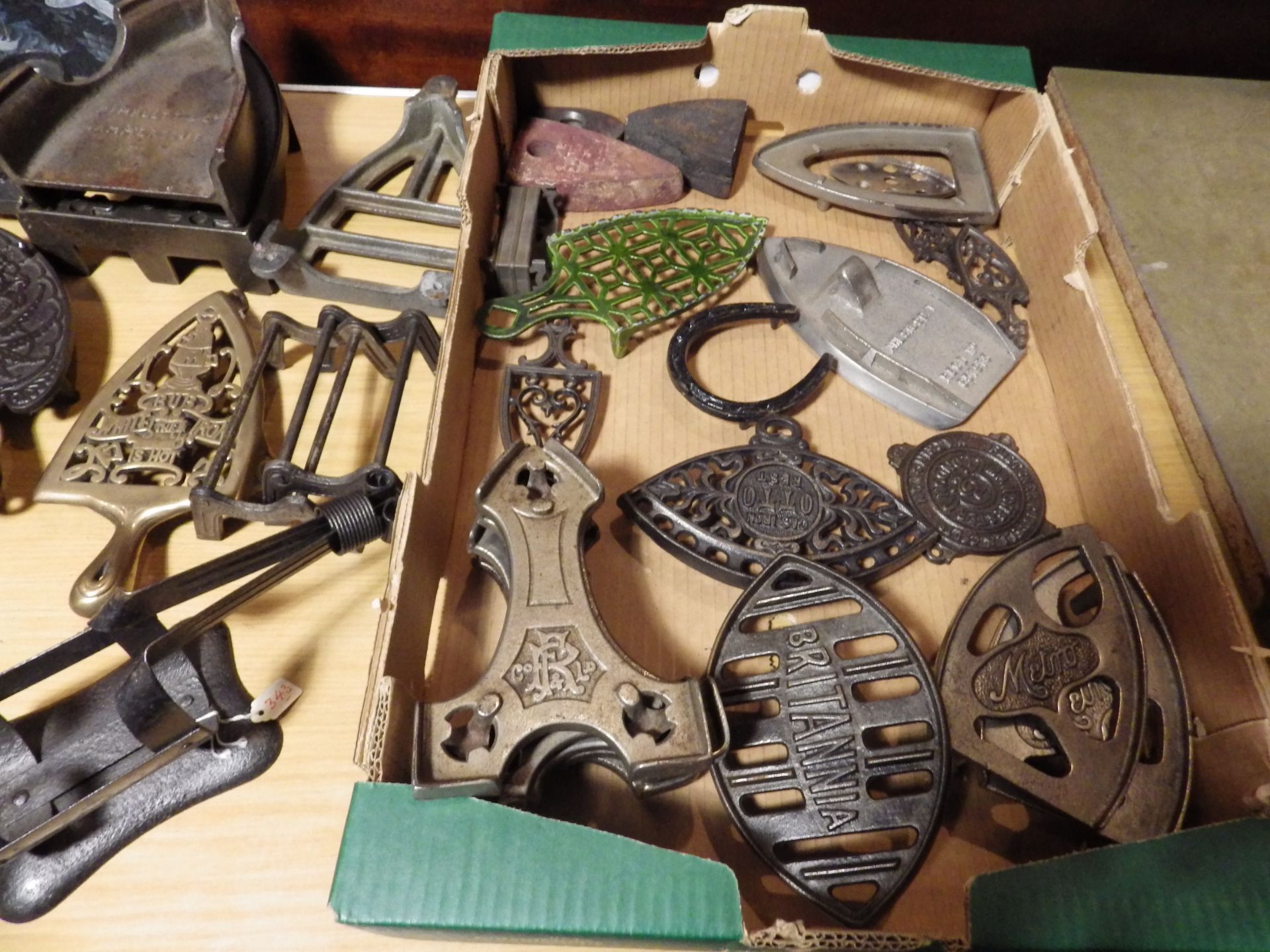 Tray of assorted iron trivets in various materials, slugs etc to include a french iron stand and - Image 2 of 3