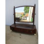 A vanity mirror with inlaid detail, porcelain feet and key