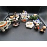 A collection of novelty teapots inc one enamelled and German priest cruet's