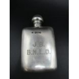 A silver hip flask with engraved initials 82gms