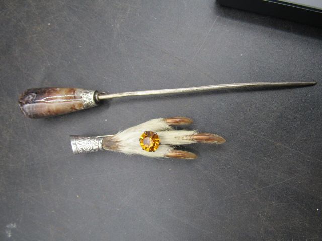 A silver grouse foot and a hat pin white metal collar