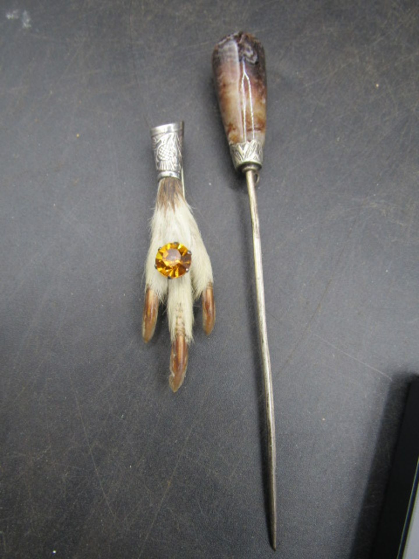 A silver grouse foot and a hat pin white metal collar