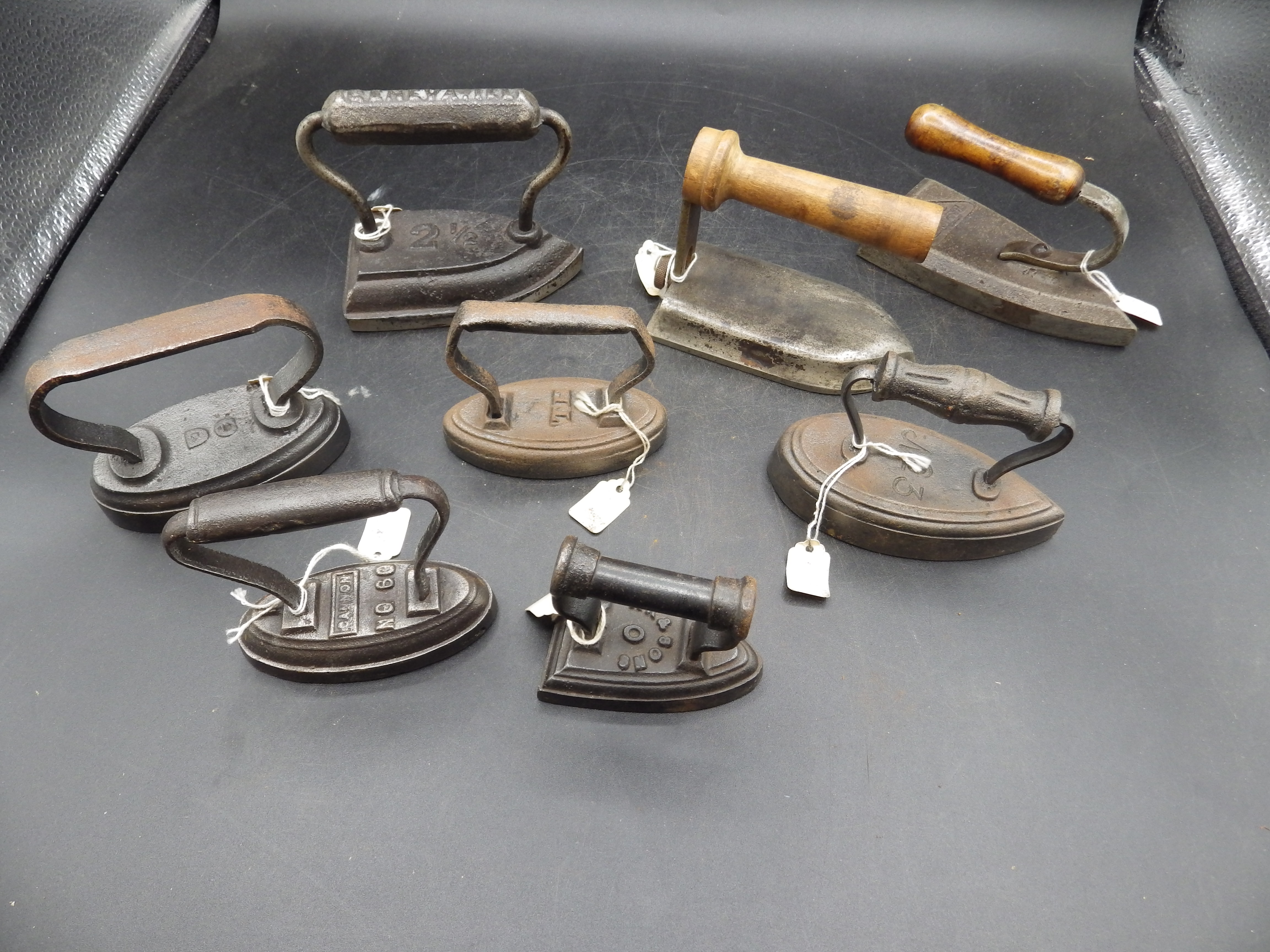 8 assorted minature irons to include hatters irons includes Geneva, TH, GC, Cannon, AK & Sons etc