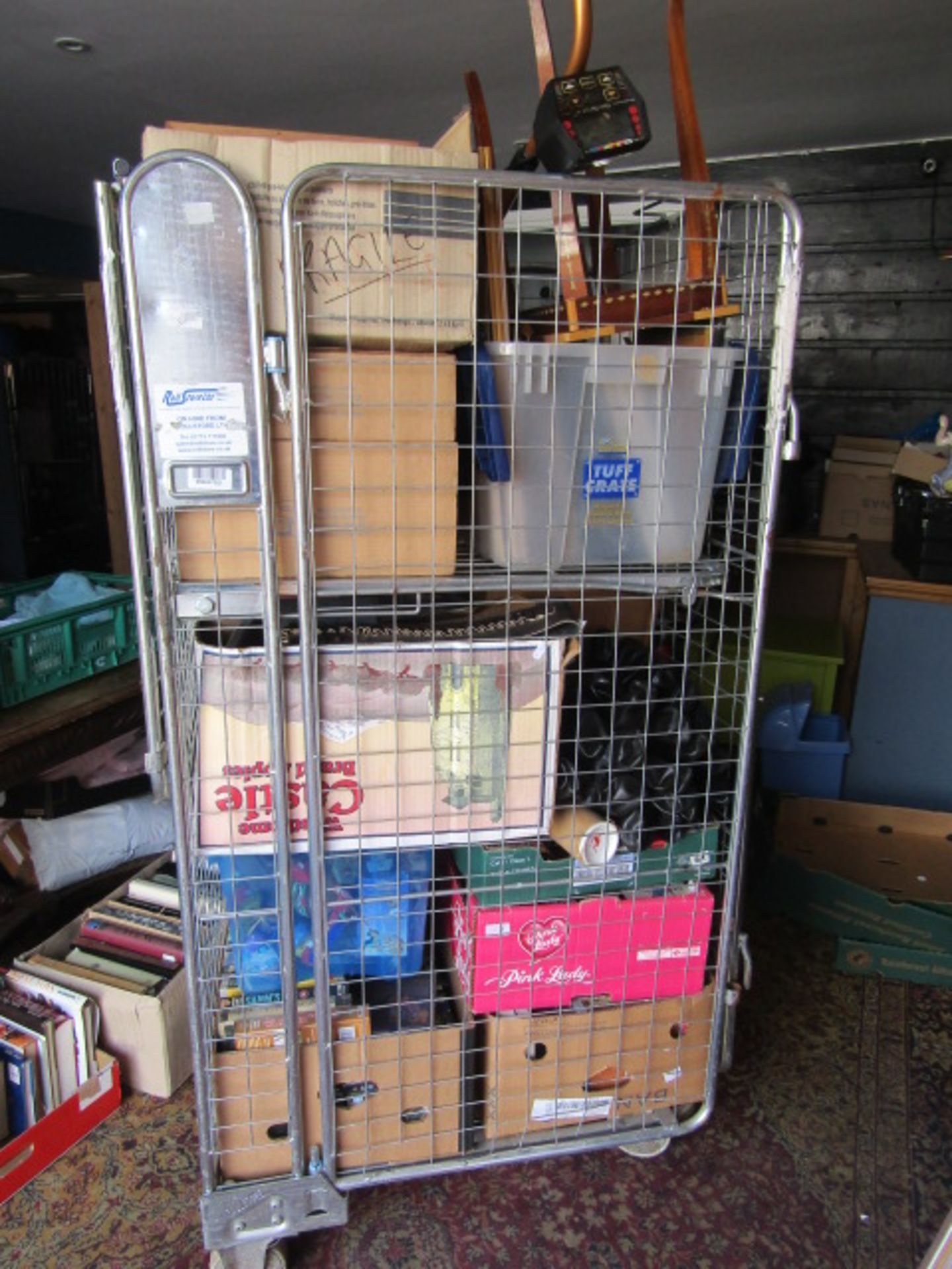 A stillage of household sundries inc metal detector, dvd's, toys etc etc stillage not included,