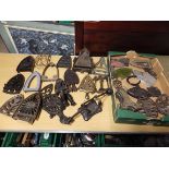 Tray of assorted iron trivets in various materials, slugs etc to include a french iron stand and