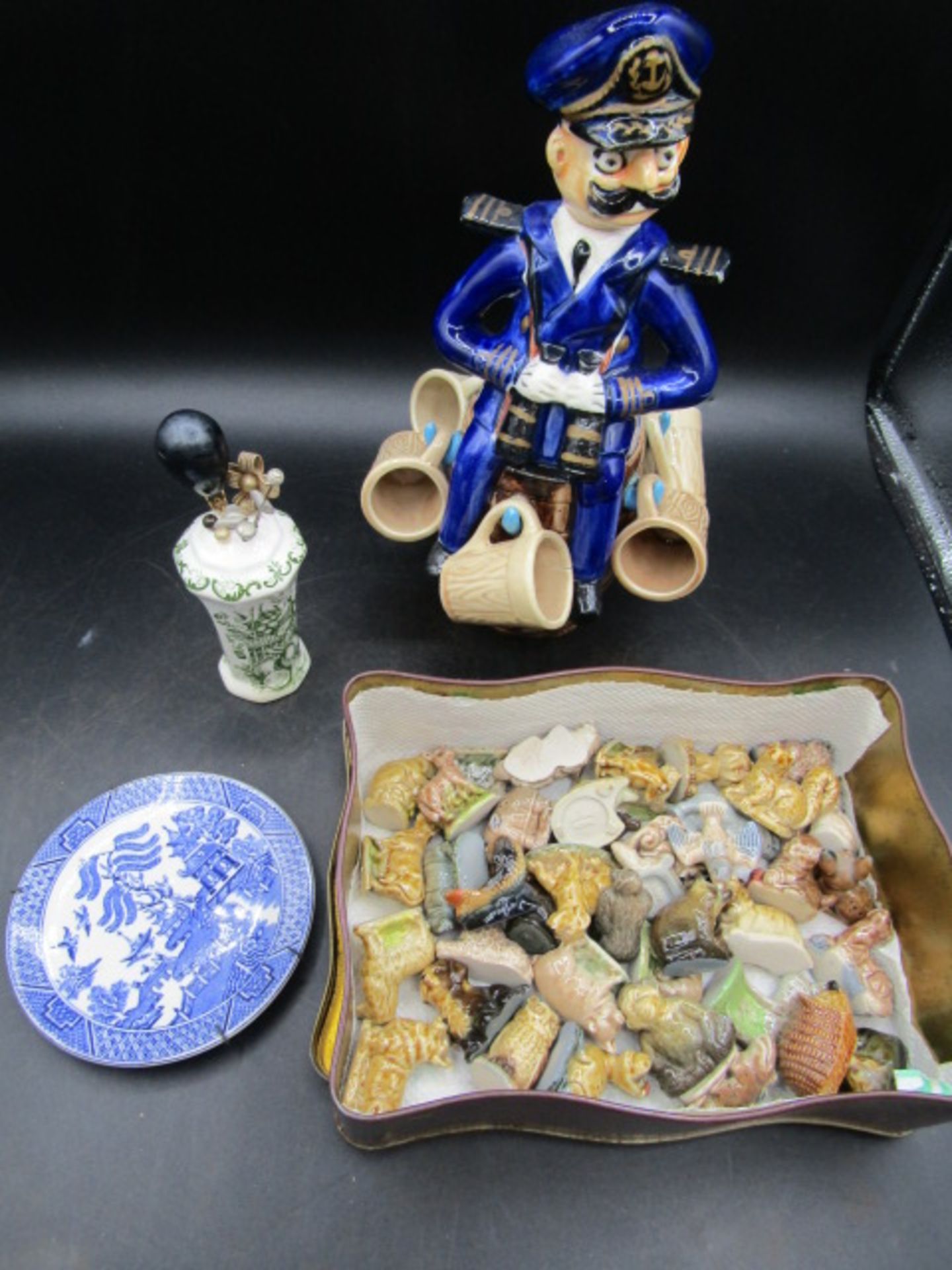 Ceramic hat pin stand with hat pins, a Naval man decanter with kegs (one has small crack),