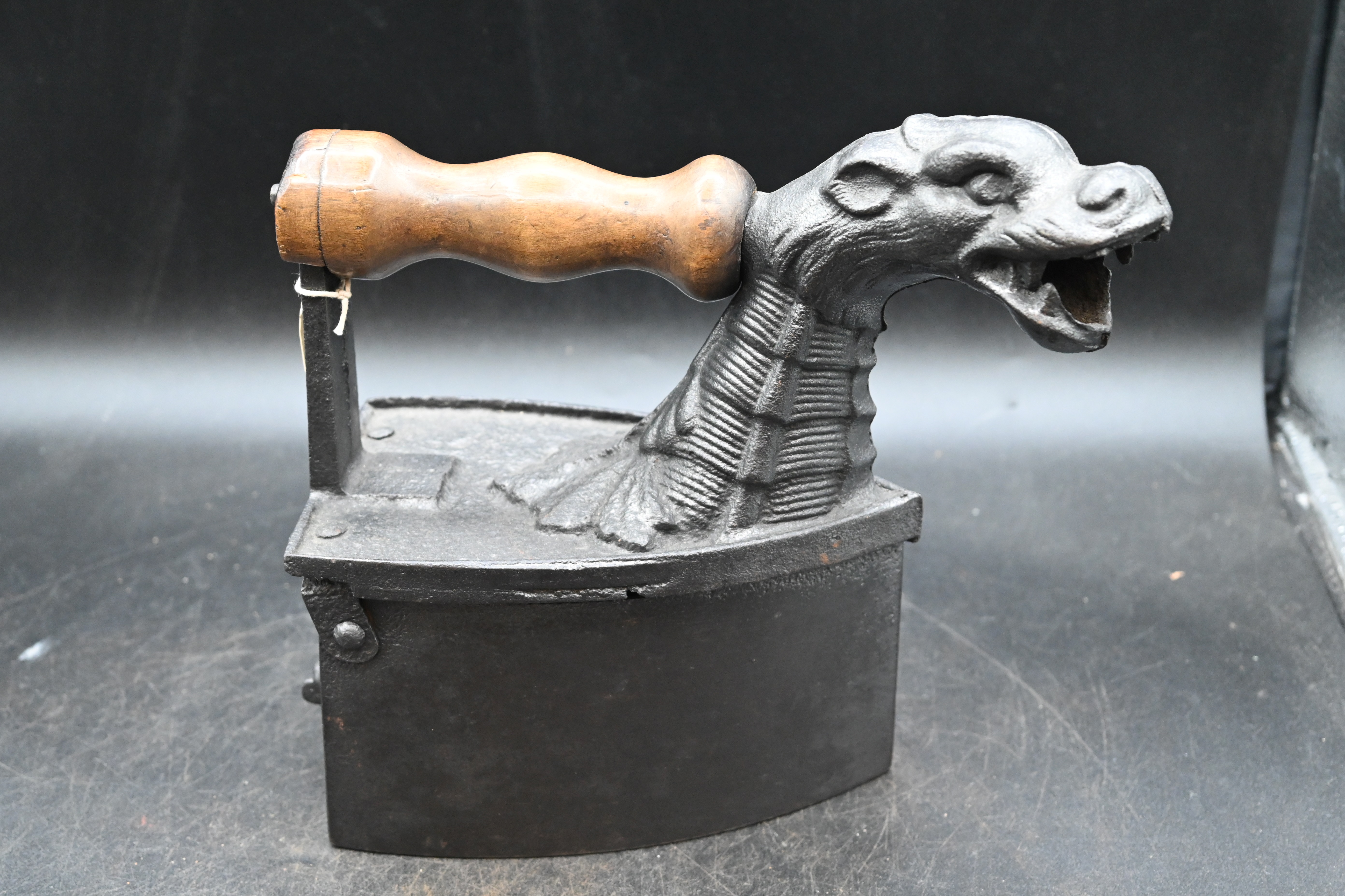 Monster charcoal iron with head of Loch Ness monster for the chimney pipe and wooden handle, circa