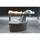 Monster charcoal iron with head of Loch Ness monster for the chimney pipe and wooden handle, circa