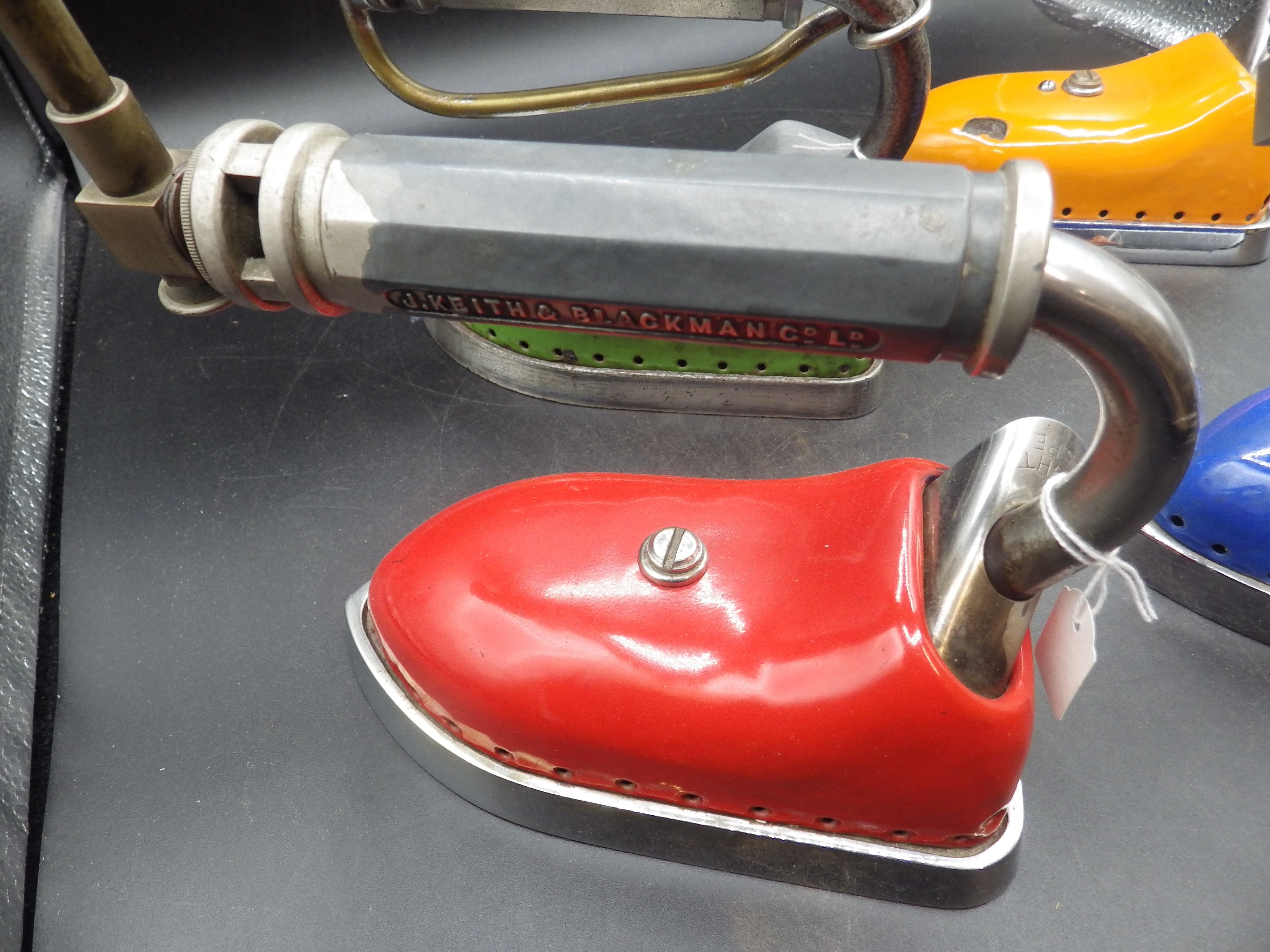 4 J Keith & Blackman Co Ltd patent 360555 coloured enamel irons in red, green, blue and orange - Image 2 of 3