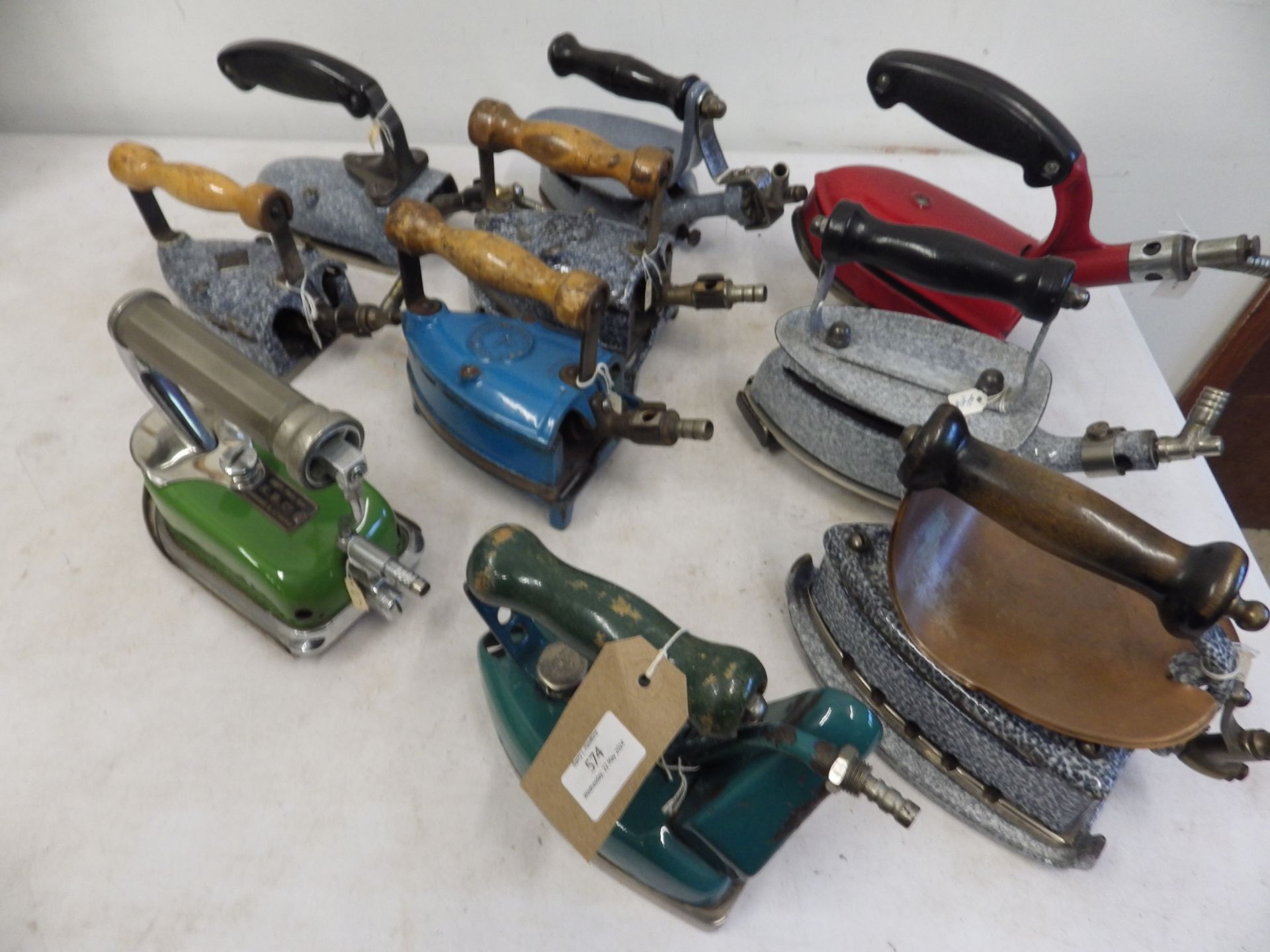 10 assorted enamel gas irons to include Fletcher Russell Laurel with trivet, MB, KB Ltd, W L Co Ltd,