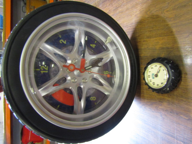 mini John Deere tyre clock and a larger tyre clock