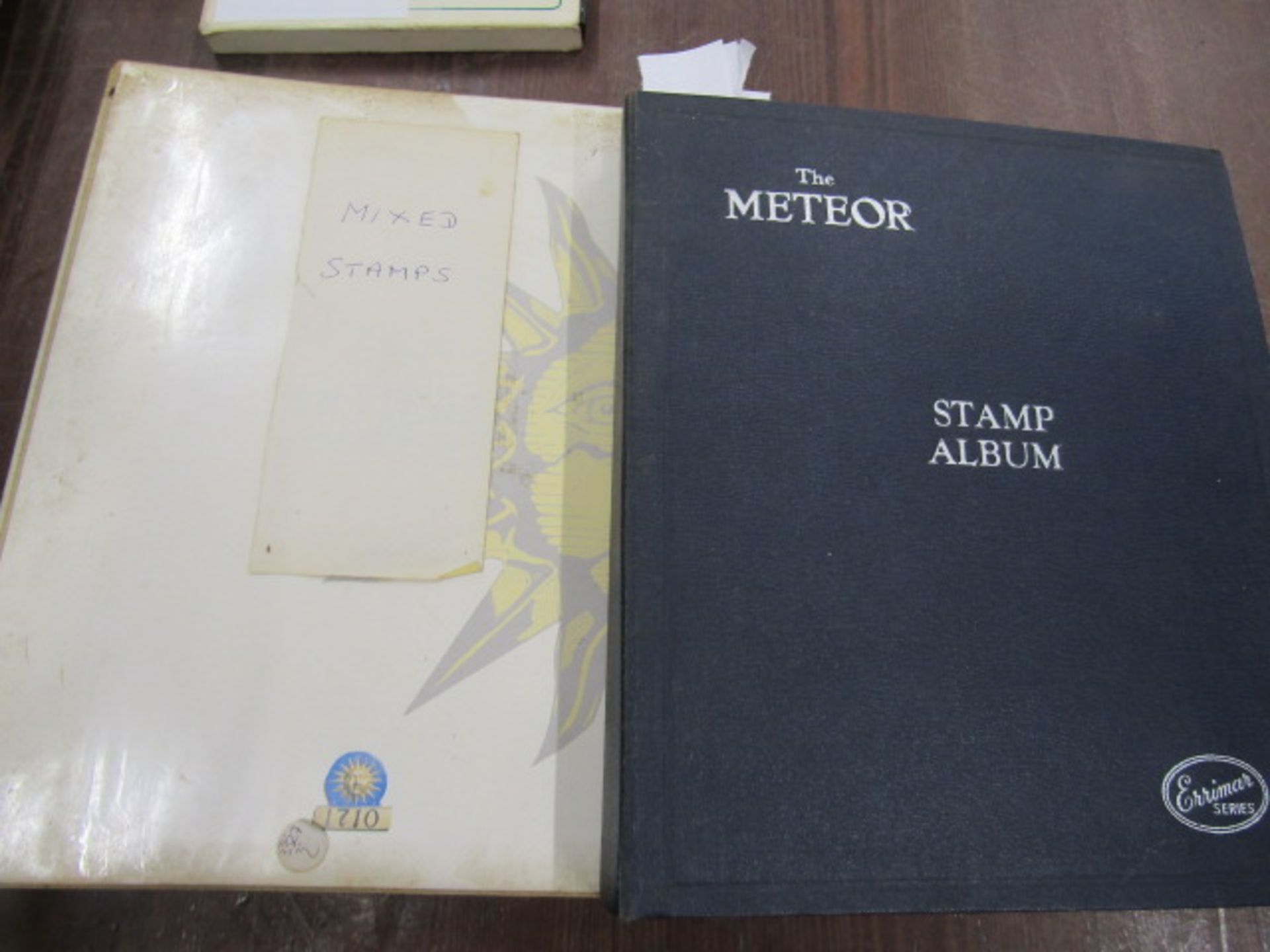 2 stamp albums, one school boy around the world and Meteor album Vic-ERII and around the world