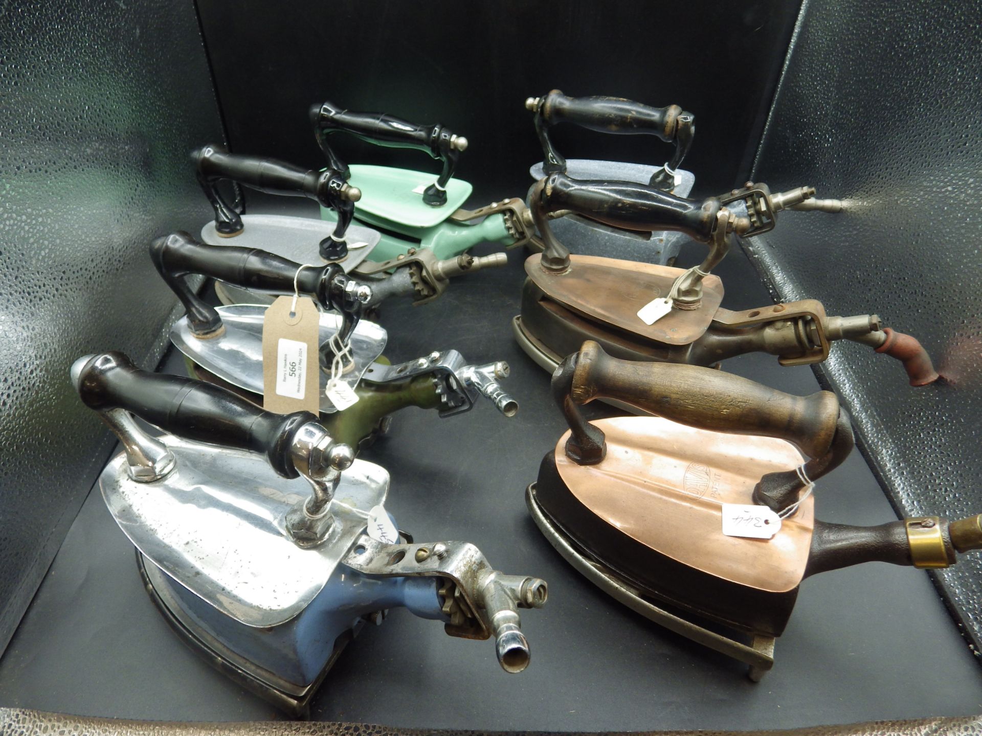 7 assorted Davis gas irons incl an early model with wood handle and flush sole, includes enamel