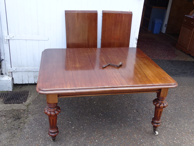 Mahogany wind out extending dining table with winder (one castor is broken as shown in pictures)