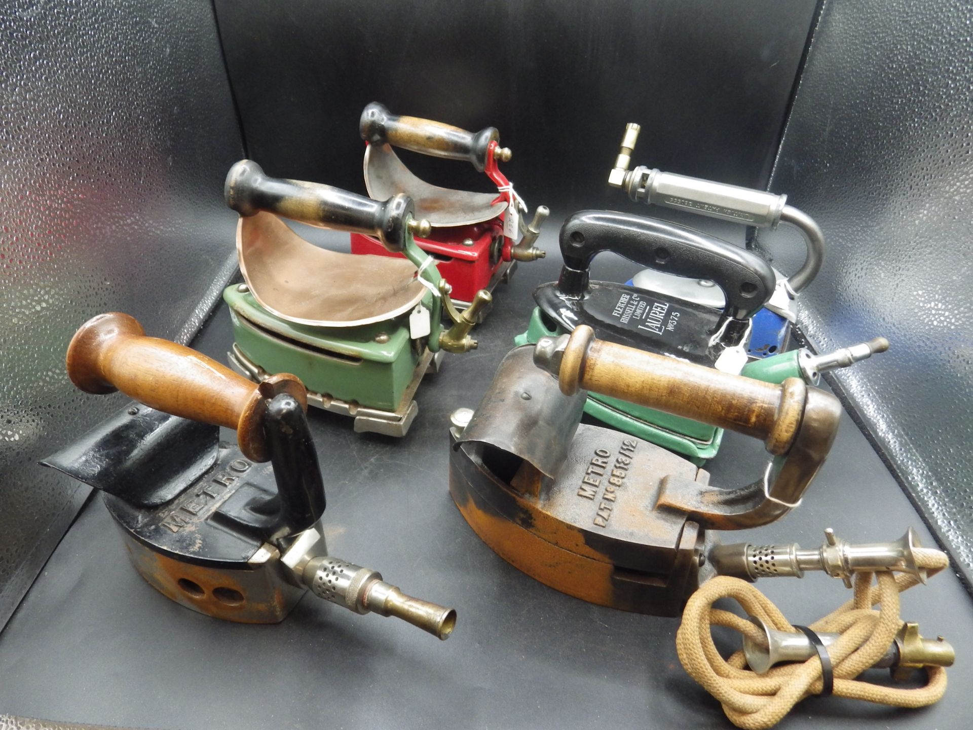 3 Fletcher Russel & Co enamel 'Laurel' gas irons, all with trivets and 2 with heat shields
