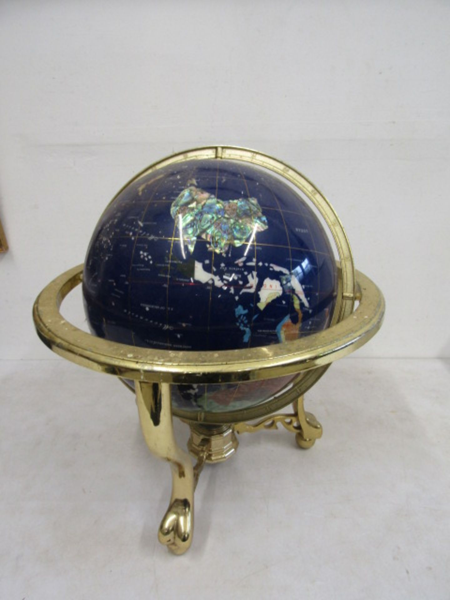 A semi-precious stone globe in stand