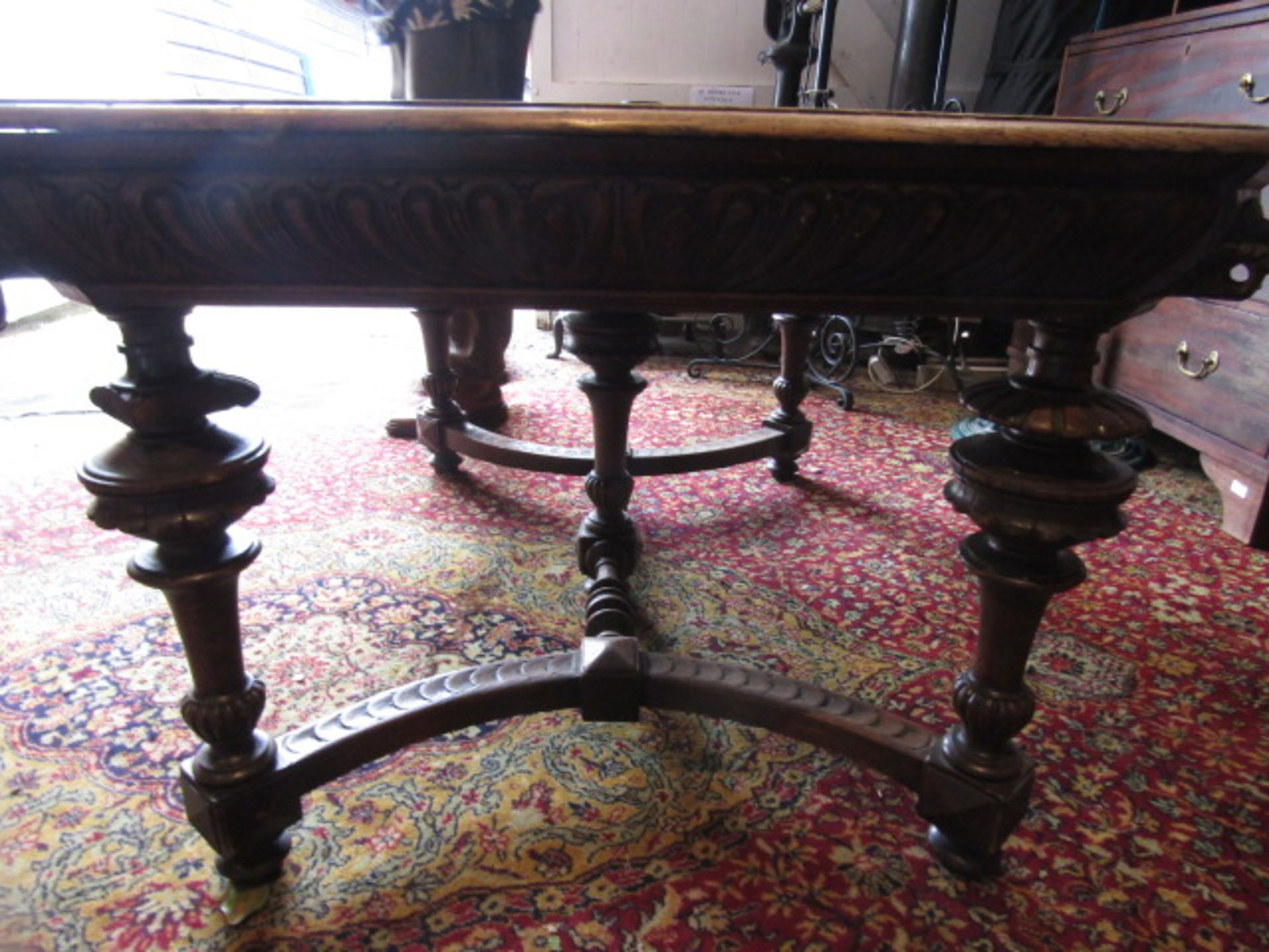 A heavily carved table with lion face details to corners 132x99cm 74cmH 2 rings missing from lion' - Image 8 of 9