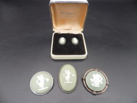 3 Wedgwood sage Jasperwear and silver brooches and a pair of clip on earings in their original box.