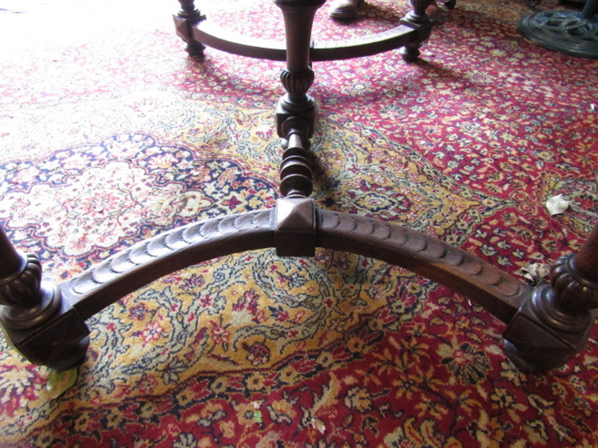 A heavily carved table with lion face details to corners 132x99cm 74cmH 2 rings missing from lion' - Image 7 of 9