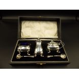 Cased, silver plated cruet set with blue glass liners
