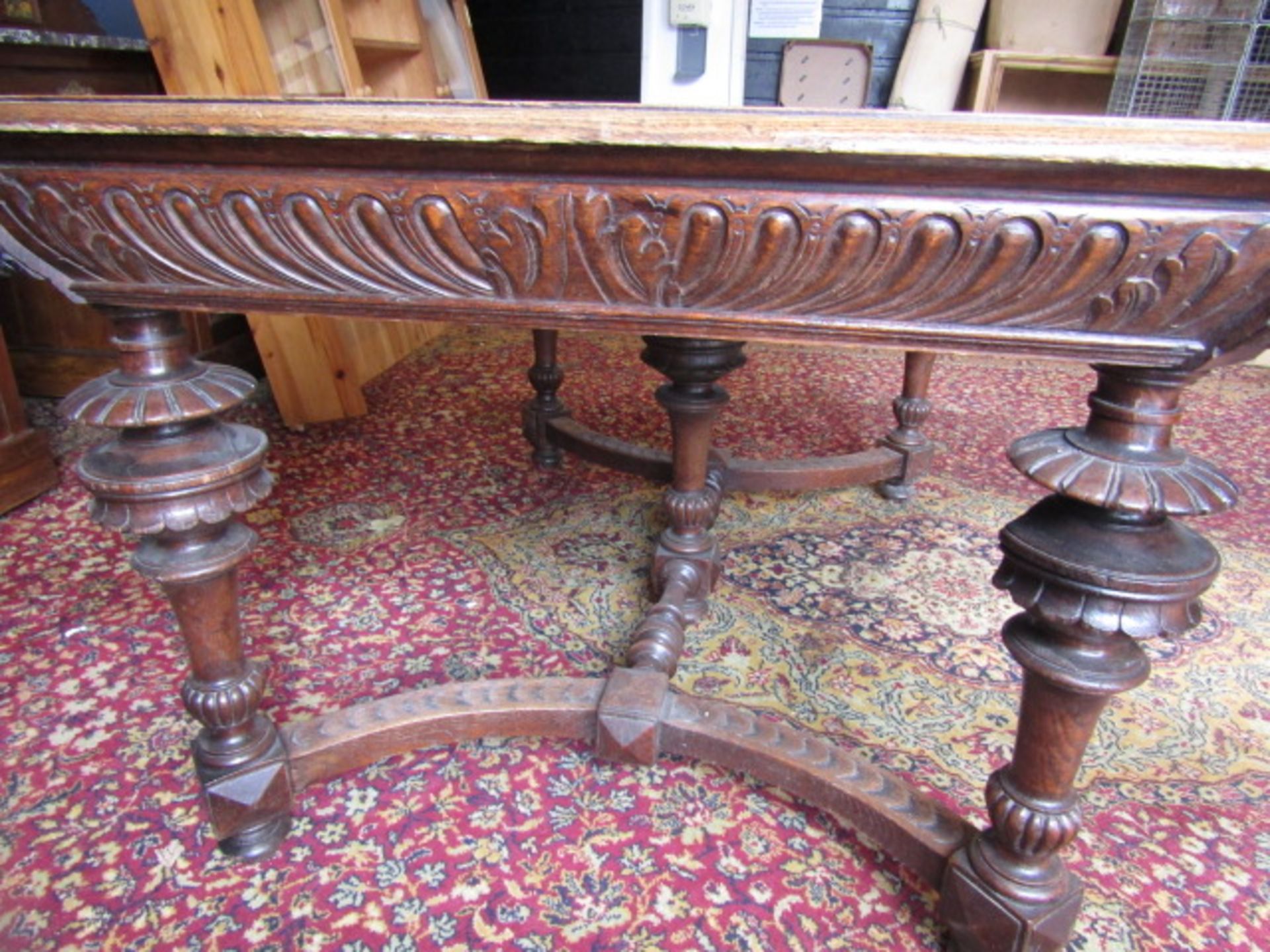 A heavily carved table with lion face details to corners 132x99cm 74cmH 2 rings missing from lion' - Image 3 of 9