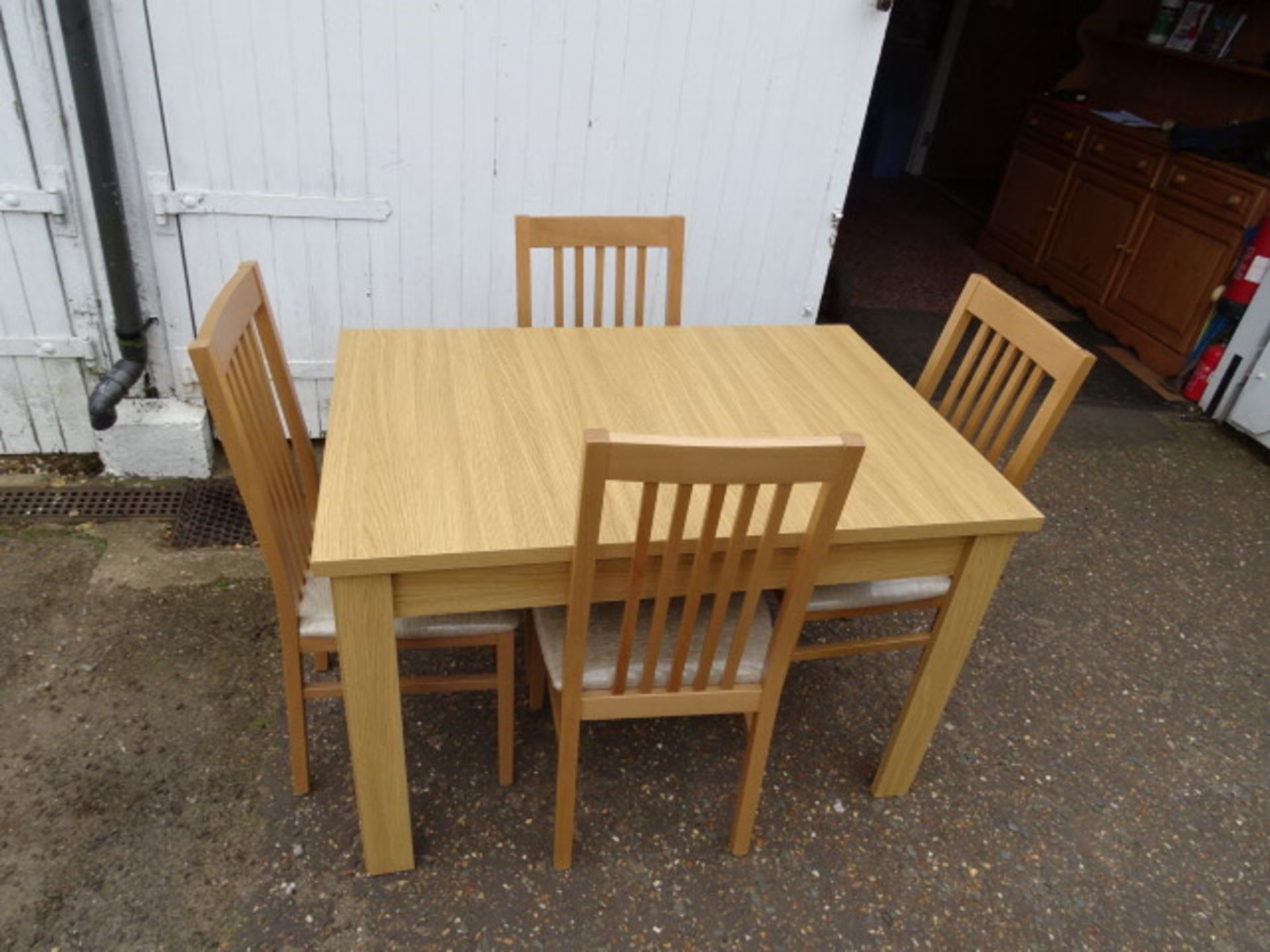 Unused extending dining table with 4 upholstered chairs brought from Reeds in Downham Market