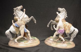 Pair of Continental men with rearing horse figures