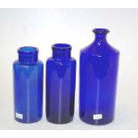 Three blue glass bottles