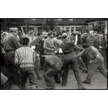 Cartier-Bresson, Henri: French forced laborers beating their former German guard...