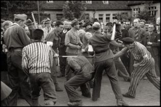 Cartier-Bresson, Henri: French forced laborers beating their former German guard...