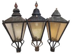 A set of three black-painted copper and acrylic lanterns,