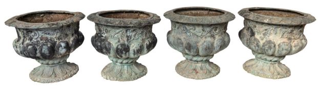 A set of four patinated metal garden urns,
