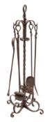 A wrought iron fire tool companion stand, 20th century; the shovel, poker,