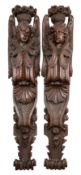 A pair of substantial carved and stained oak angel herms, or door casement bearers,
