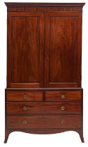 A Regency mahogany linen press, early 19th century; with moulded cornice above twin panel doors,
