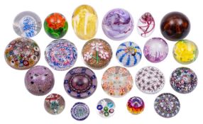 A mixed group of twenty four glass paperweights, including Murano, Scottish, Swarovski,