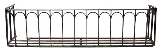 A black painted wrought iron balcony guard,